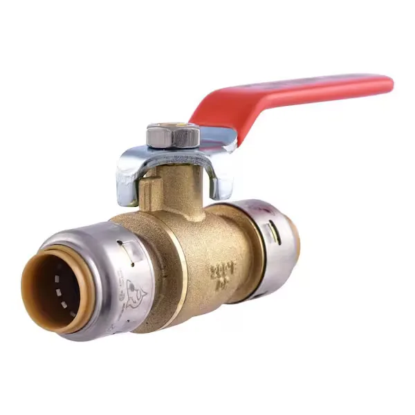 Brass ball valve with a red lever handle on a main water line