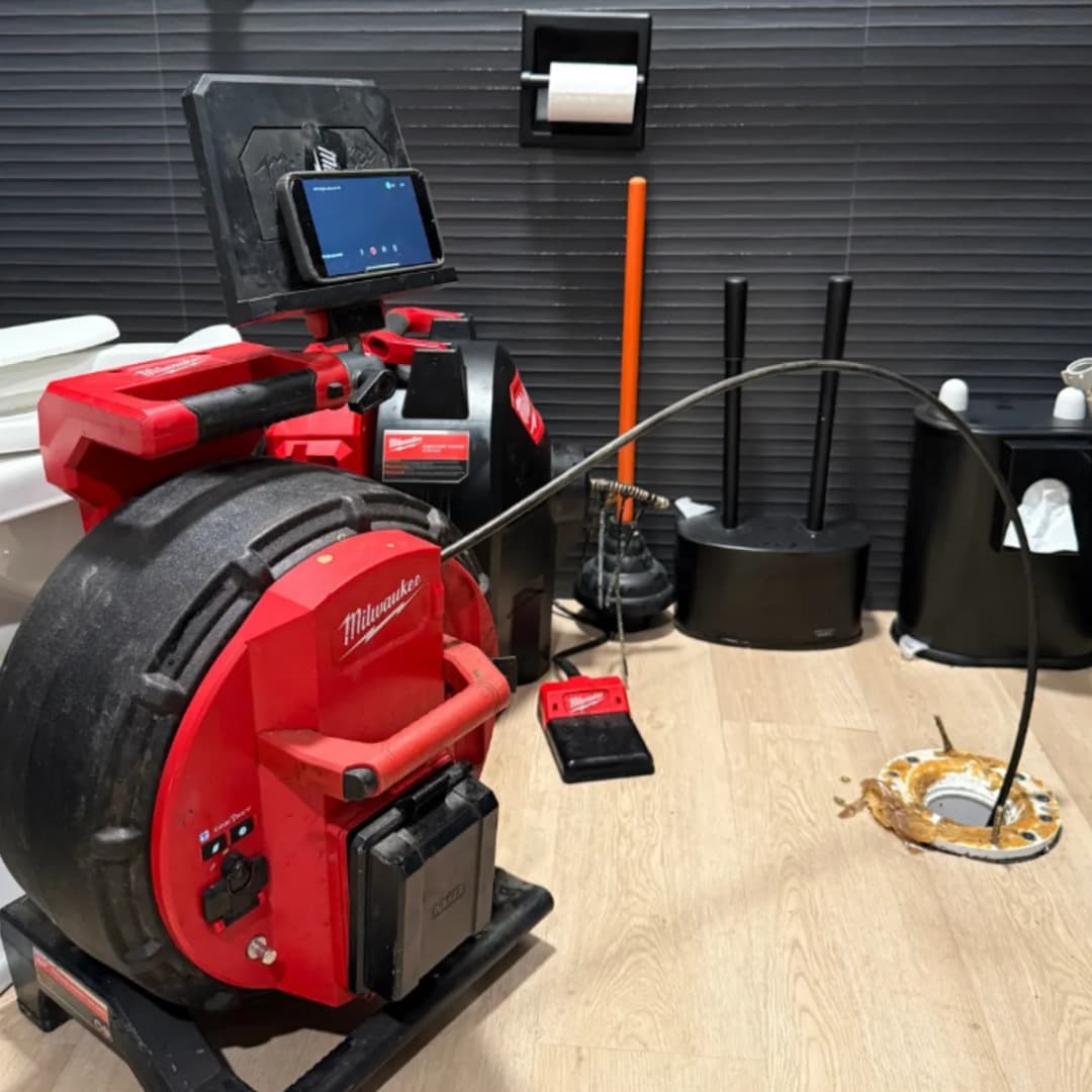 Licensed NSP Plumbing technician performing a sewer camera inspection in a Grand Rapids basement.