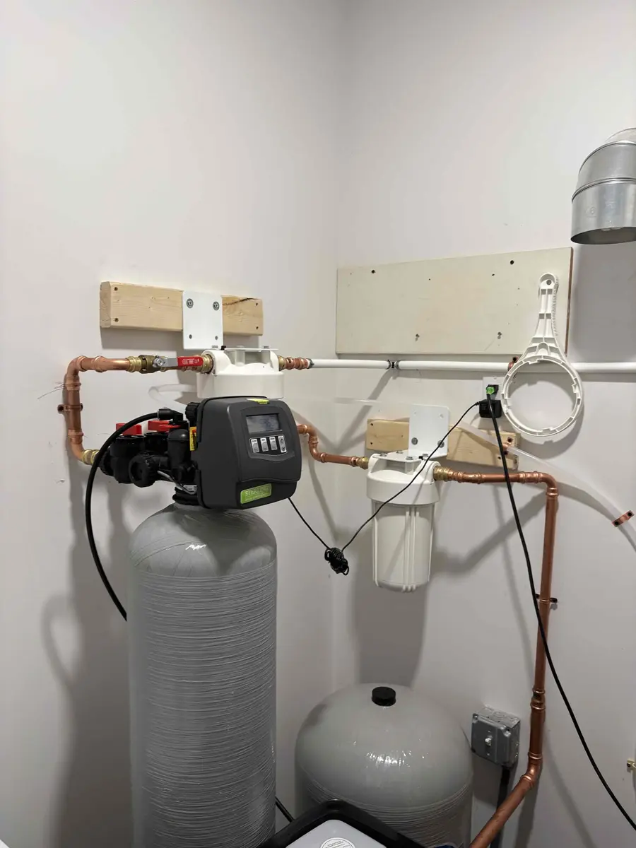 New water softener installed with a bypass valve and whole home sediment filter