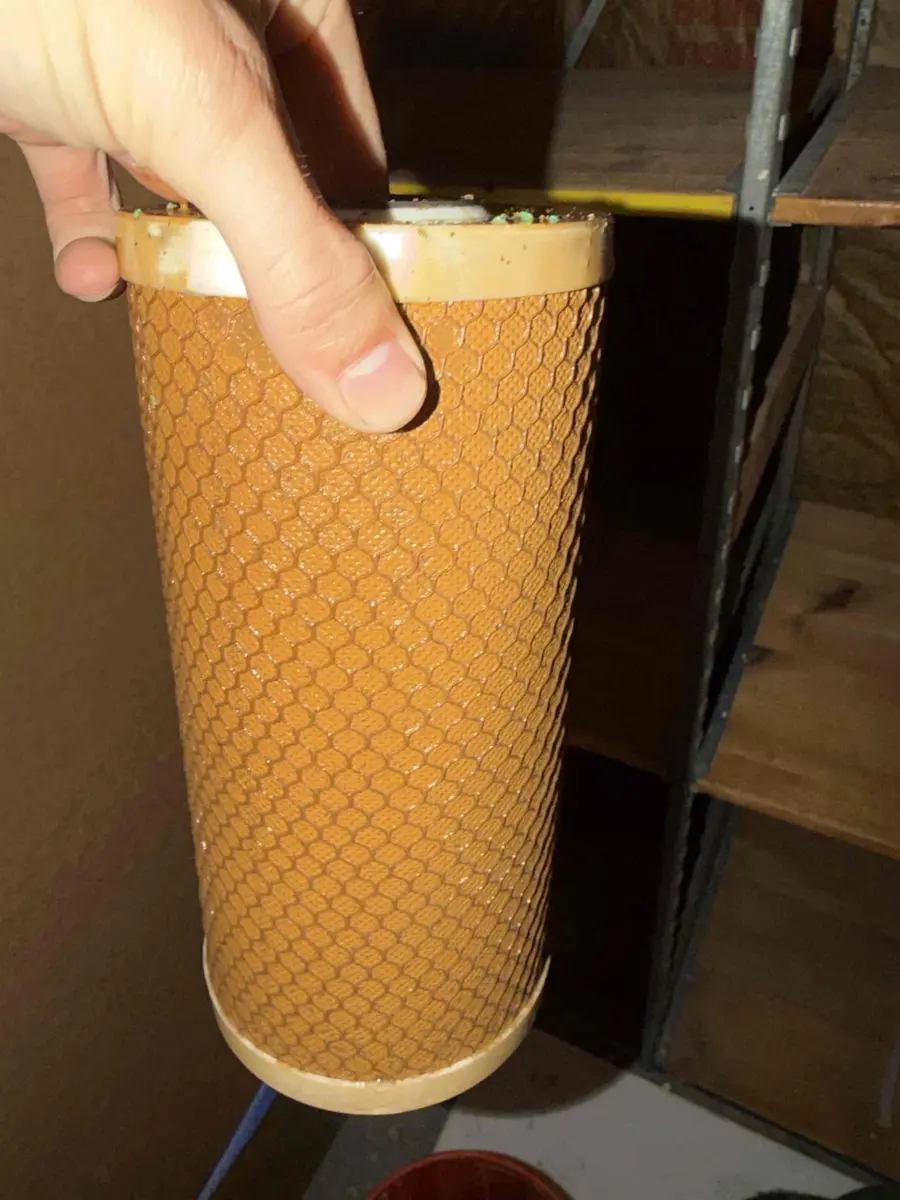 Whole home sediment filter cartridge coated in orange iron deposits