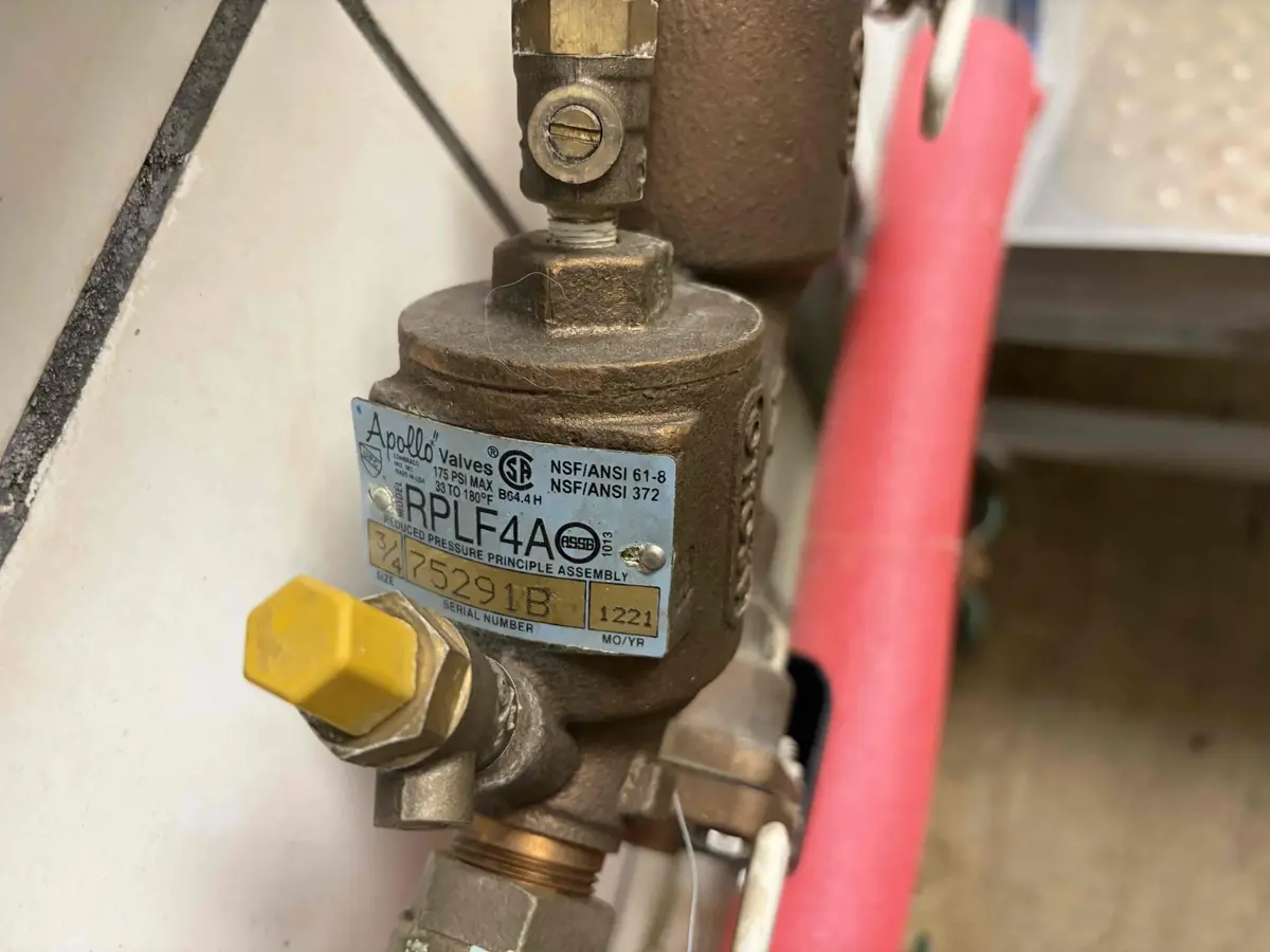 Brass reduced pressure backflow assembly on a home water supply line