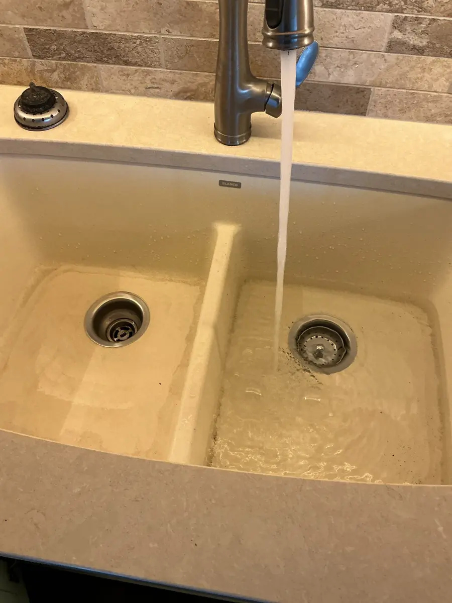 Double kitchen sink draining freely after a clogged kitchen drain was cleared