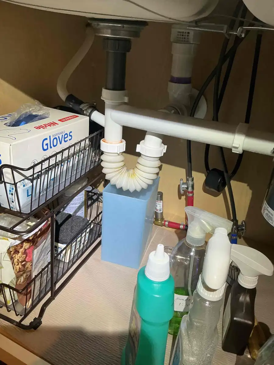Flexible ribbed accordion style drain trap installed under a bathroom sink