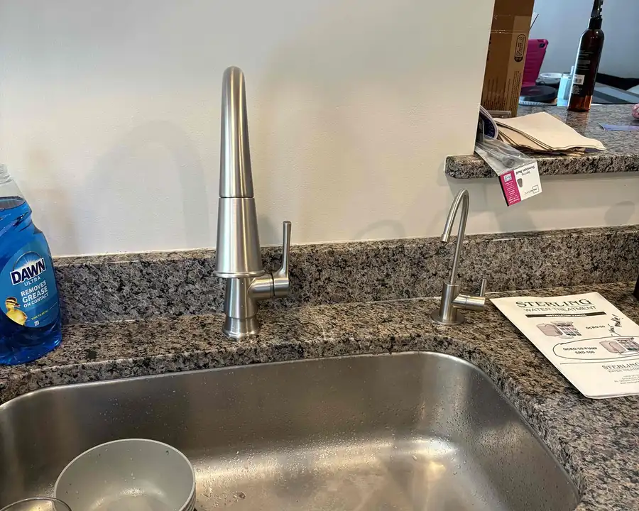 Kitchen sink with a dedicated reverse osmosis drinking water faucet installed next to the main faucet