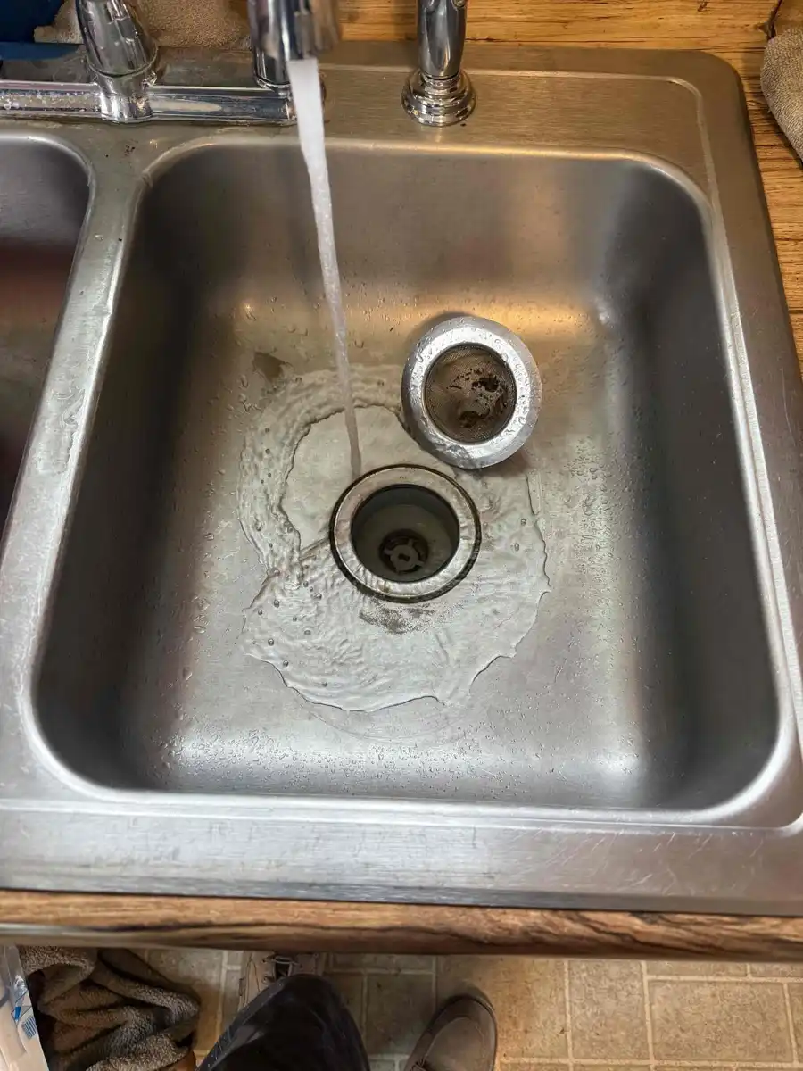 Kitchen sink draining freely after the clogged drain was opened