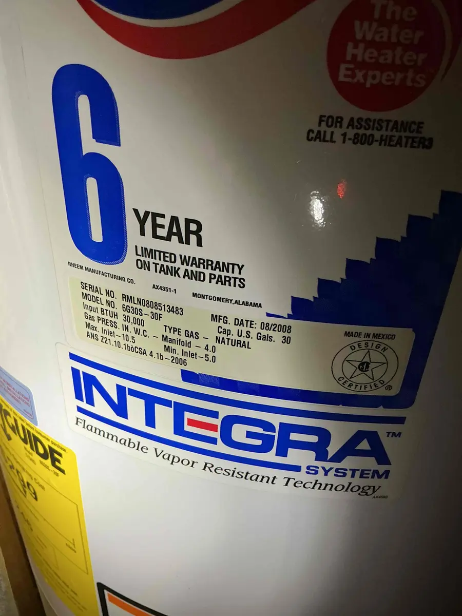 The data label on a Rheem water heater showing a manufacturing date of August 2008 and a 6-year limited warranty