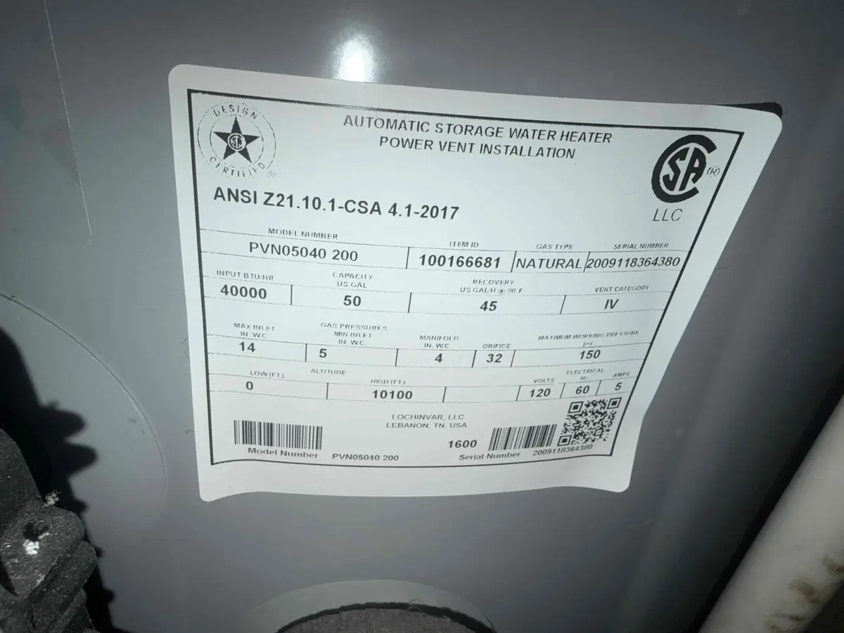 The data plate on a Lochinvar power vent water heater showing the model number, serial number, capacity, BTU rating, and gas type