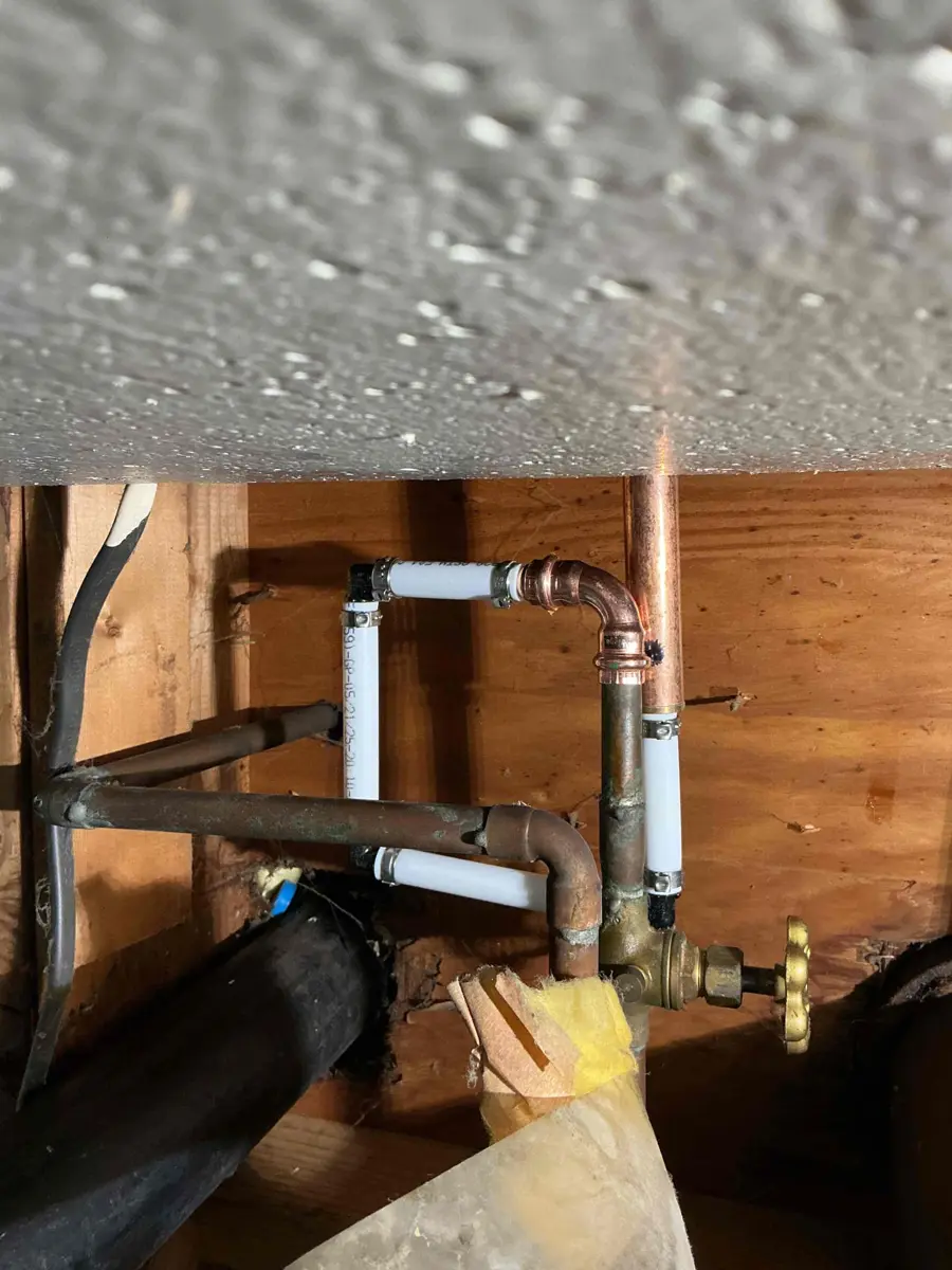 Round handle shutoff valve on a basement water line feeding an outdoor faucet