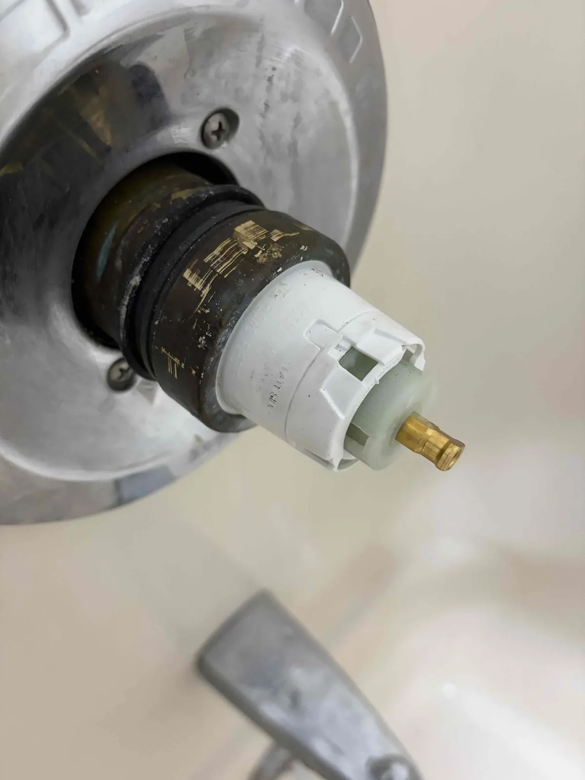 Shower cartridge partly pulled out of the brass valve body