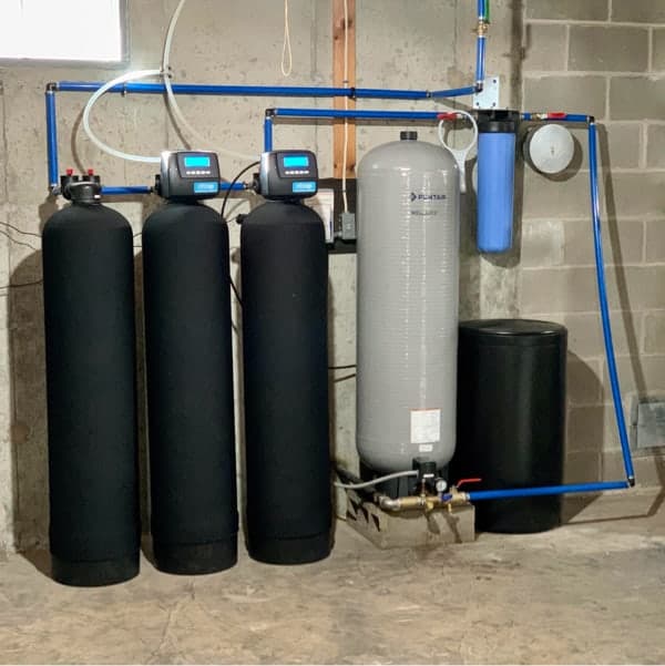 NSP Plumbing installing a whole-house water filtration system in a Grand Rapids, MI home